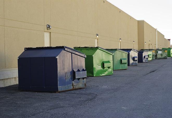 construction workers disposing of debris in large dumpsters in Warsaw, NY